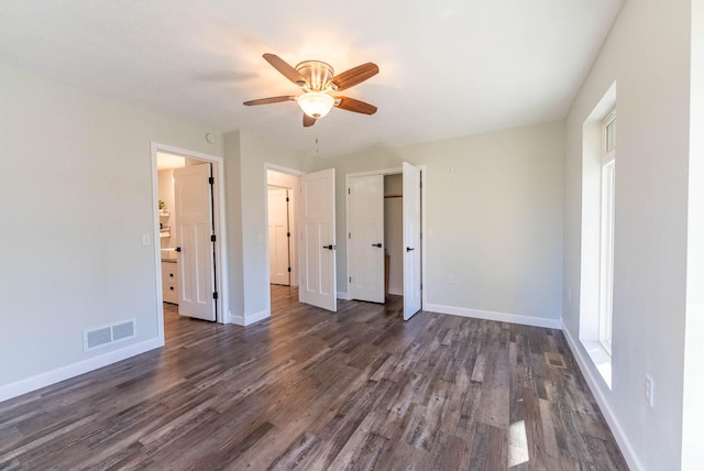 unfurnished bedroom with ceiling fan and dark hardwood / wood-style flooring