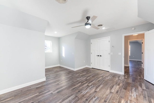 spare room with ceiling fan and dark wood-type flooring