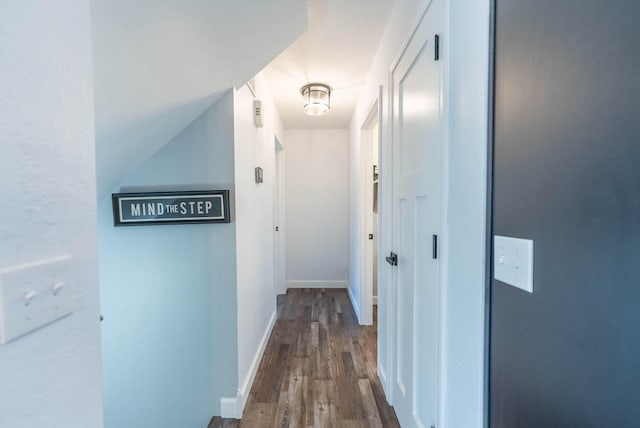 corridor with hardwood / wood-style flooring