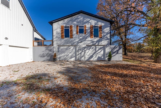 exterior space featuring a wooden deck and a garage