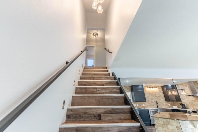 stairway with an inviting chandelier