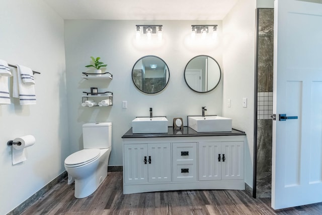 bathroom with hardwood / wood-style floors, vanity, and toilet