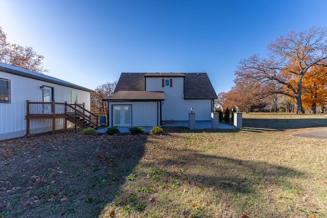 rear view of property with a lawn