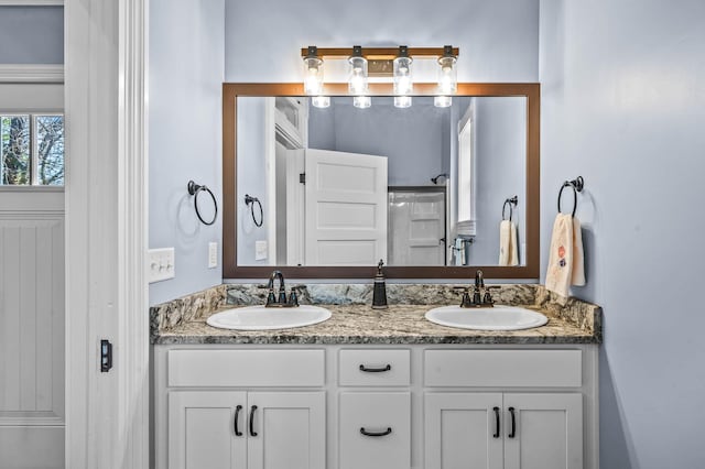 bathroom featuring vanity and a shower with shower door