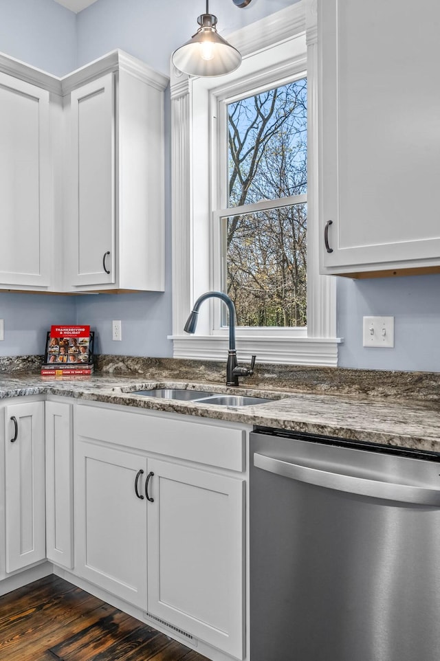 kitchen with white cabinets, dark hardwood / wood-style flooring, stainless steel dishwasher, and sink