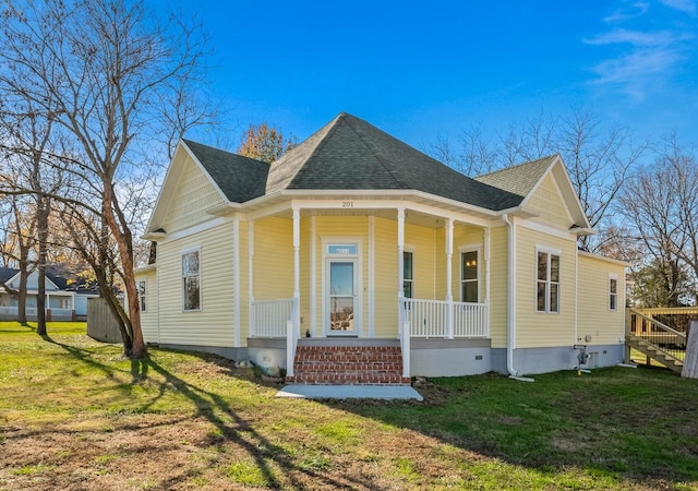 view of property exterior with a yard and covered porch