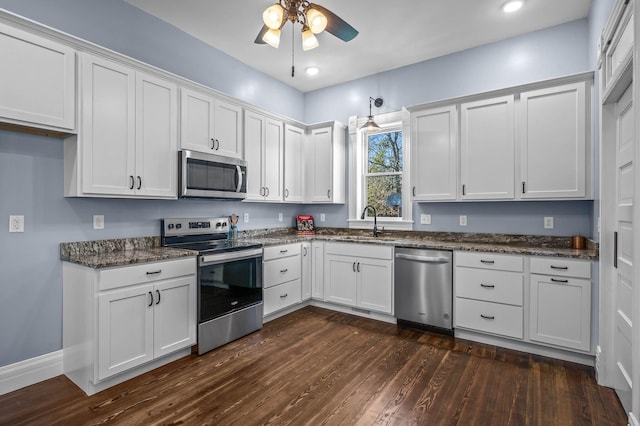 kitchen featuring dark hardwood / wood-style flooring, stainless steel appliances, ceiling fan, sink, and white cabinets