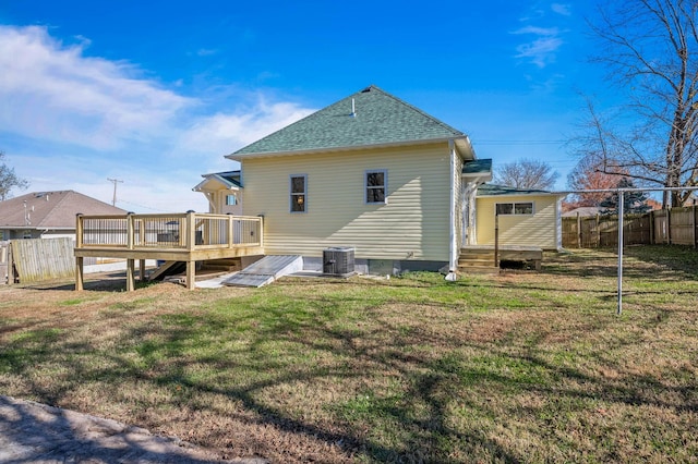 back of house featuring a yard, central AC unit, and a deck