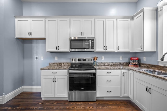 kitchen with appliances with stainless steel finishes and white cabinetry