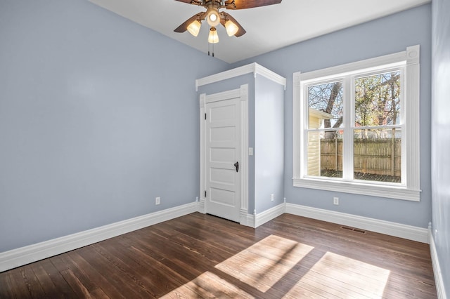 unfurnished bedroom featuring ceiling fan and dark wood-type flooring