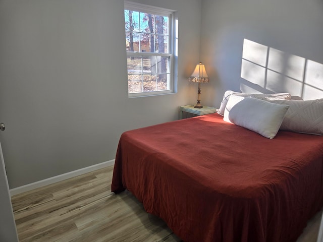 bedroom with hardwood / wood-style floors