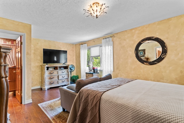 bedroom featuring a textured ceiling and hardwood / wood-style flooring