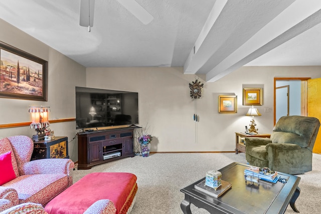 carpeted living room featuring ceiling fan and a textured ceiling