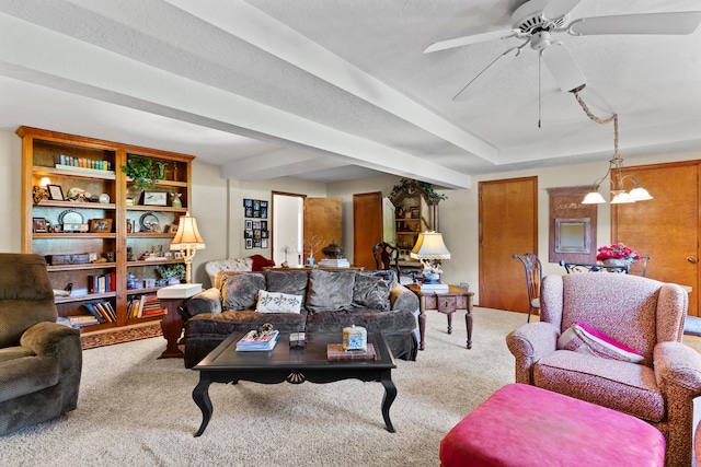 carpeted living room with ceiling fan with notable chandelier and a textured ceiling