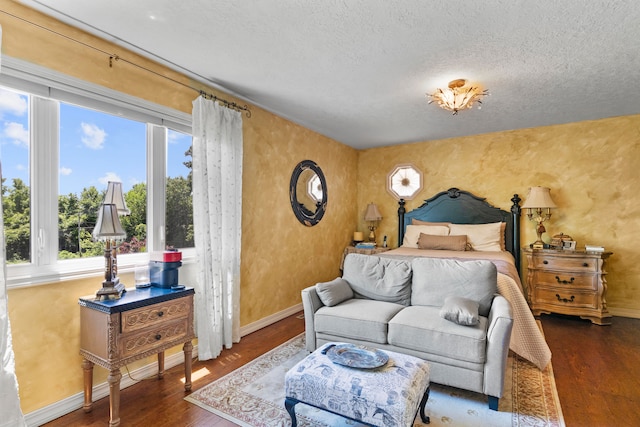 bedroom featuring a textured ceiling and dark wood-type flooring