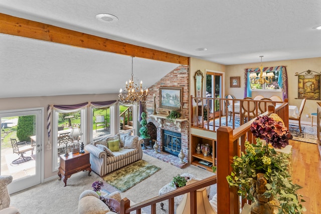 living room featuring hardwood / wood-style floors, vaulted ceiling with beams, a textured ceiling, a fireplace, and a chandelier