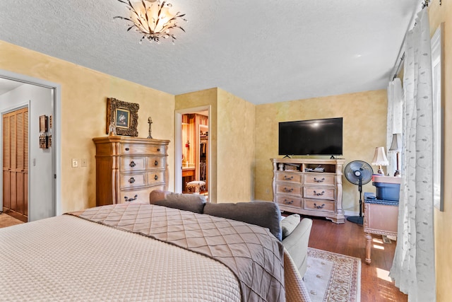 bedroom featuring a textured ceiling, hardwood / wood-style flooring, and a closet