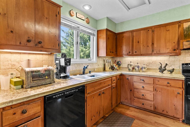 kitchen featuring dishwasher, light hardwood / wood-style floors, decorative backsplash, and sink