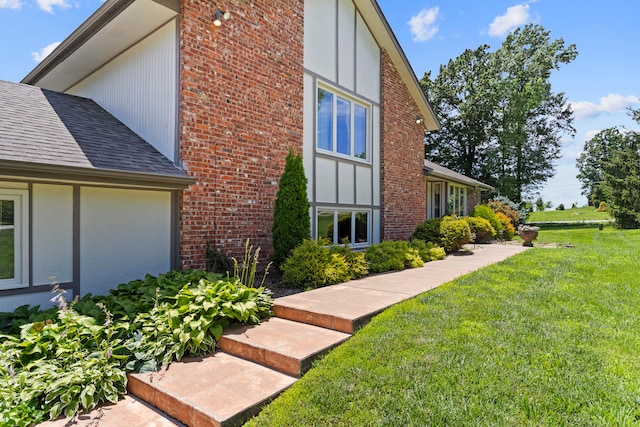 view of side of property with a yard