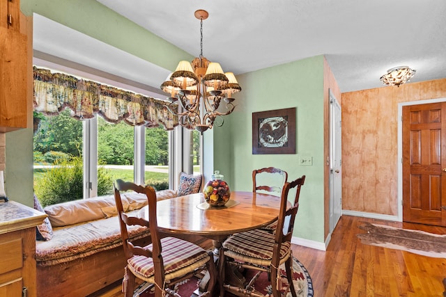 dining room featuring hardwood / wood-style flooring, a textured ceiling, and a chandelier