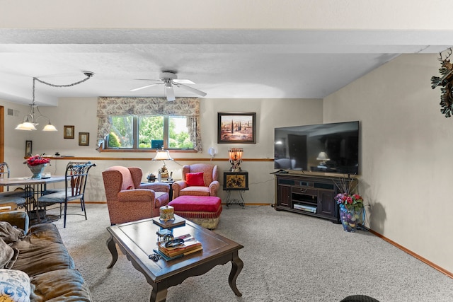 living room with carpet flooring and ceiling fan with notable chandelier