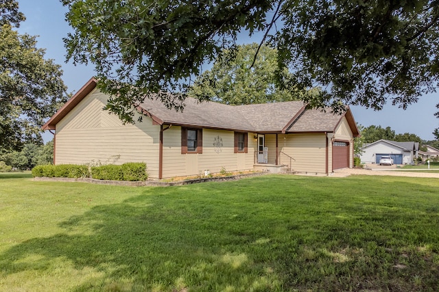 ranch-style home with a front yard and a garage