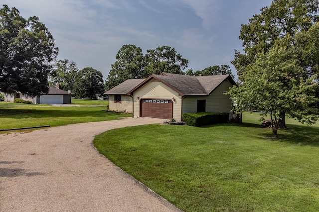 ranch-style home with a garage and a front lawn