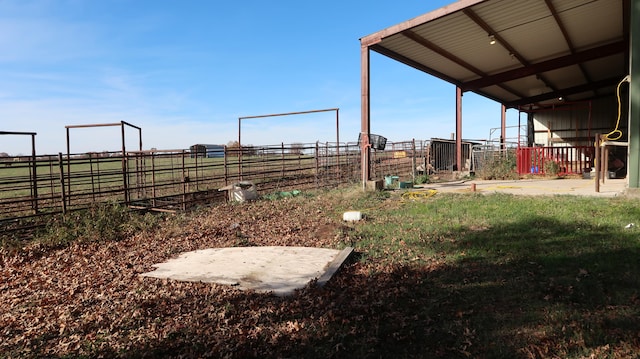 view of yard featuring a rural view and an outdoor structure