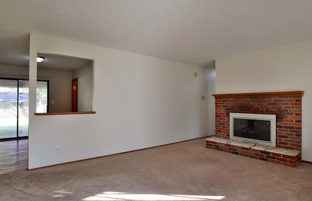 unfurnished living room with carpet flooring and a fireplace