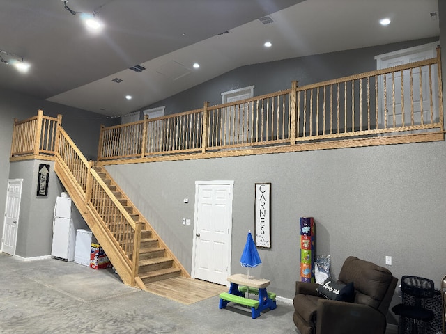 living room featuring wood-type flooring and vaulted ceiling