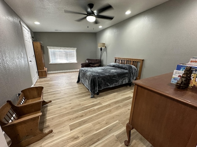 bedroom featuring ceiling fan and light hardwood / wood-style floors