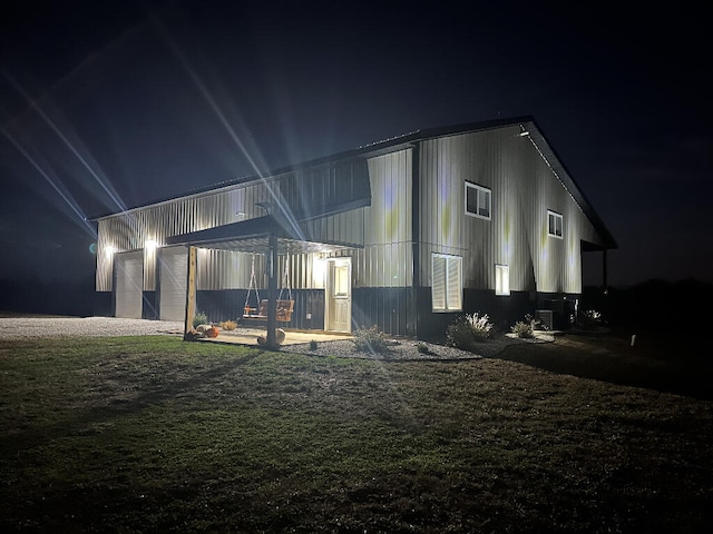 back house at twilight with an outbuilding