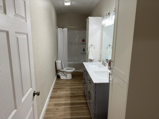 full bathroom with toilet, hardwood / wood-style floors, vanity, and shower / tub combo with curtain