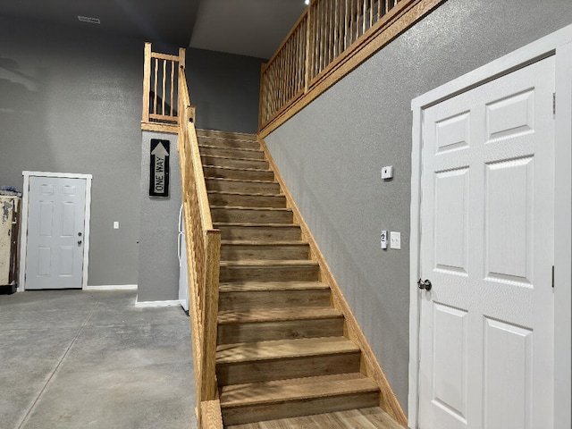 staircase with concrete floors