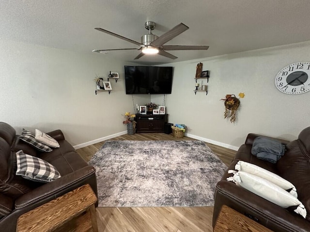 living room featuring hardwood / wood-style floors and ceiling fan