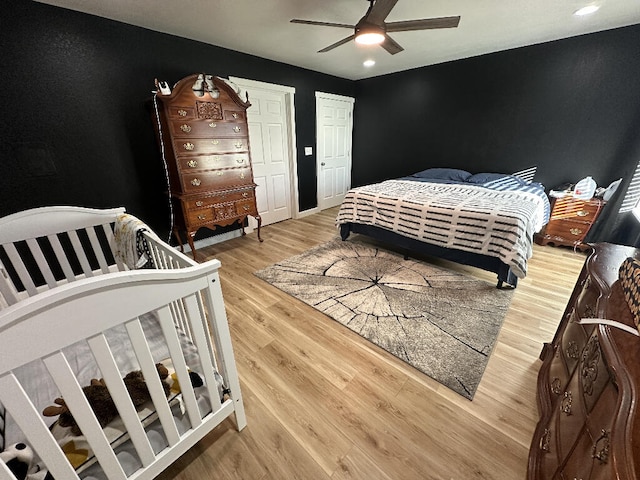 bedroom with hardwood / wood-style flooring and ceiling fan