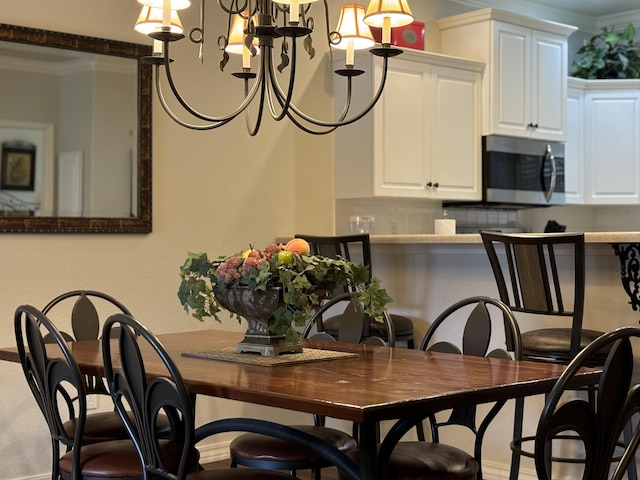 3830 Green Mountain Dr Unit 104, Branson, MO 65616 - dining area featuring a chandelier and crown molding