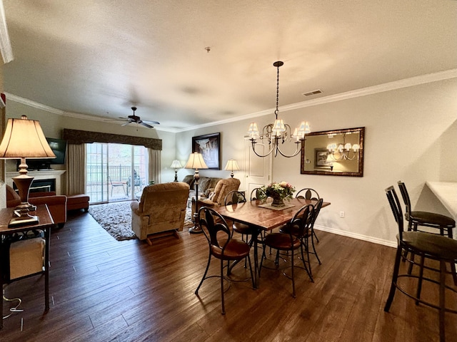 3830 Green Mountain Dr Unit 104, Branson, MO 65616 - dining area with dark wood-style flooring, a fireplace, ornamental molding, a chandelier, and ceiling fan