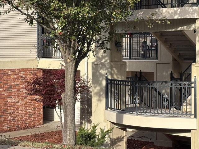 3830 Green Mountain Dr Unit 104, Branson, MO 65616 - view of home's exterior with stucco siding and a balcony