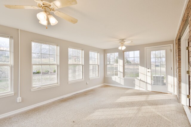 unfurnished sunroom with a wealth of natural light and ceiling fan