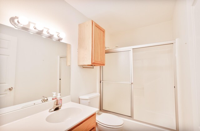 full bathroom with toilet, combined bath / shower with glass door, and vanity