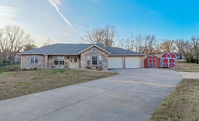 single story home with a front lawn and a shed