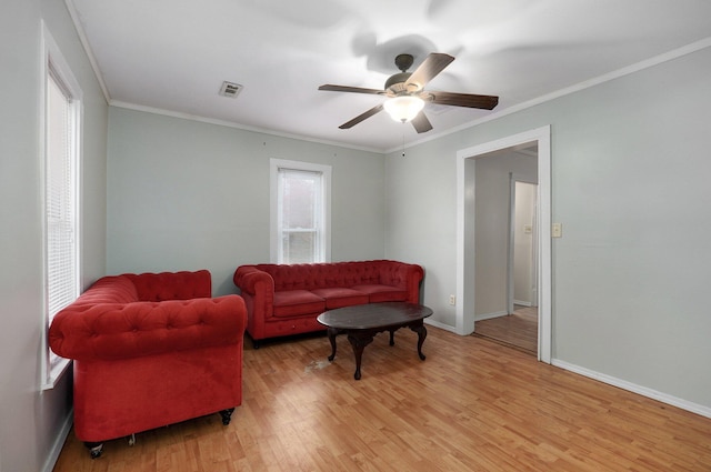 living room with ceiling fan, crown molding, and light hardwood / wood-style flooring