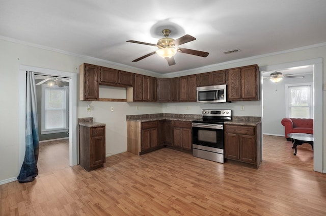 kitchen with dark brown cabinets, light wood-type flooring, stainless steel appliances, and crown molding