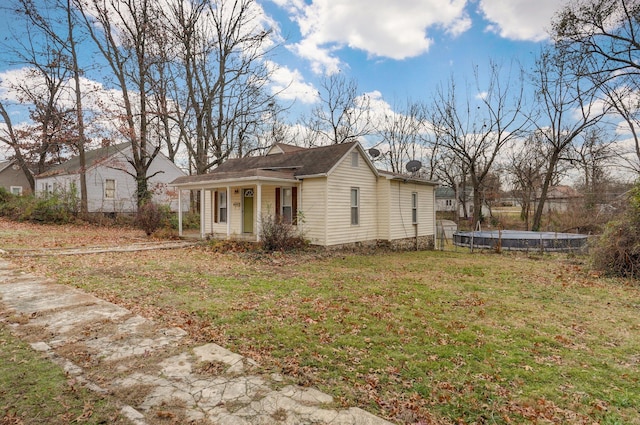 exterior space with a porch and a front lawn