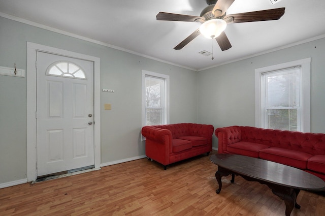 living room with crown molding, ceiling fan, and light wood-type flooring