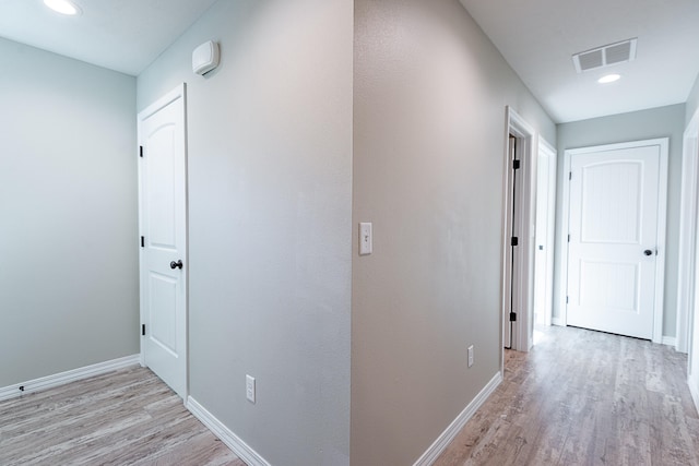 corridor with light hardwood / wood-style flooring