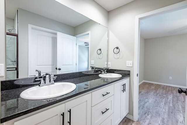 bathroom with hardwood / wood-style floors and vanity