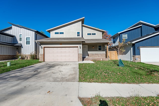 view of front of home with a front yard and a garage