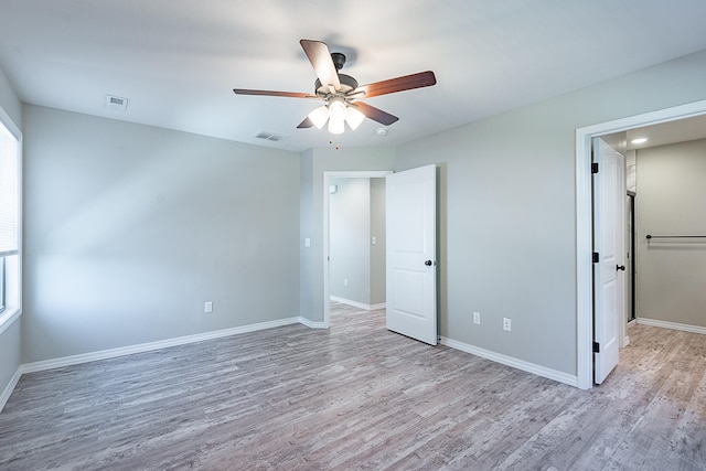 unfurnished bedroom with ceiling fan and light hardwood / wood-style floors